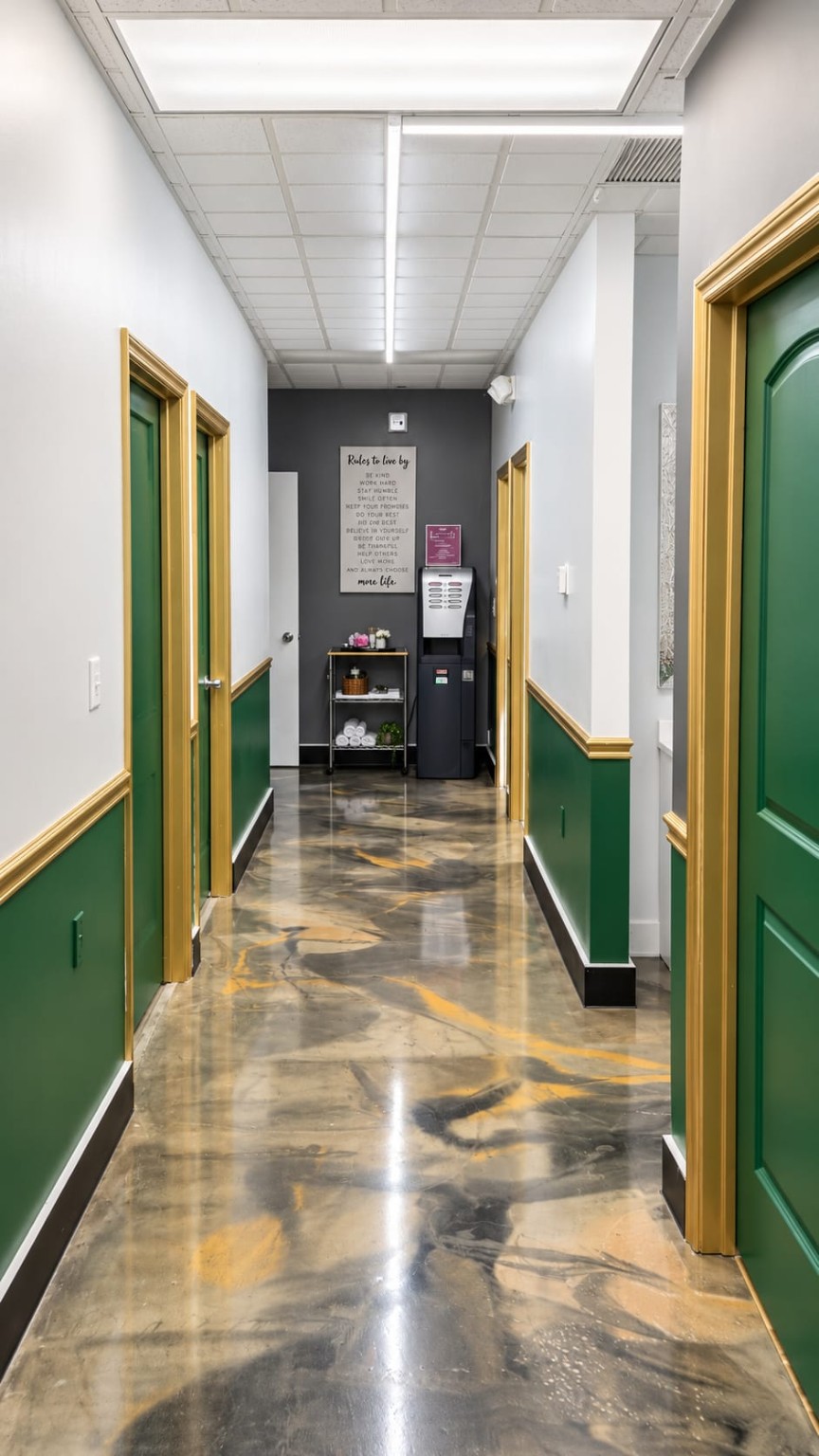 The boutique hallway with green doors and gold trim