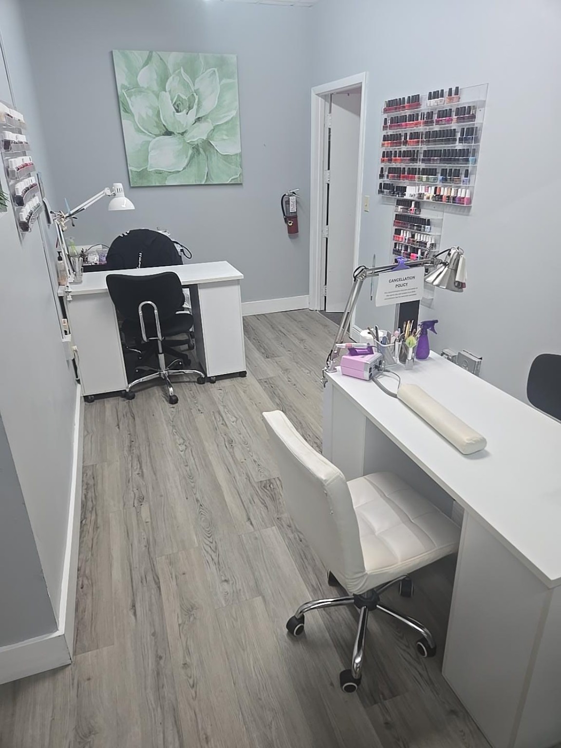 The nail studio with manicure stations and a collection of polish colors